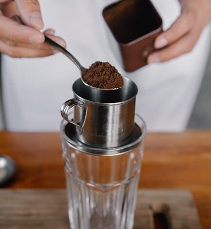 a person pouring a coffee into a glass cup